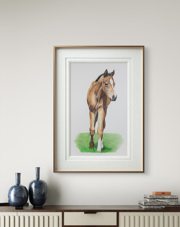 Framed painting of a horse on a wall above a cabinet with decorative items.