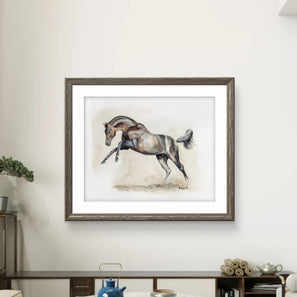 Framed artwork of a horse on a wall in a room with a desk and decor items.