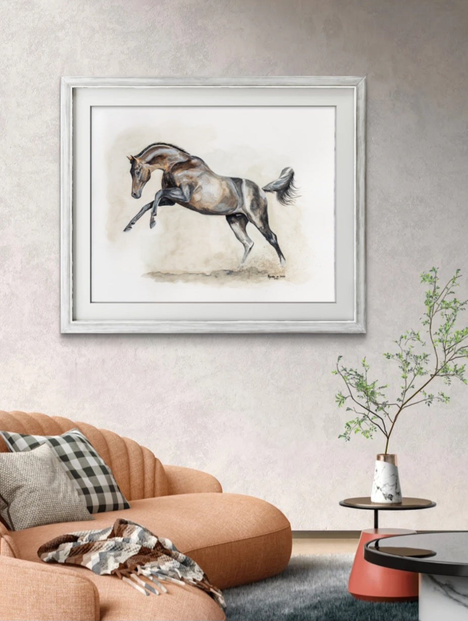 Framed artwork of a horse on a wall above a sofa in a living room.