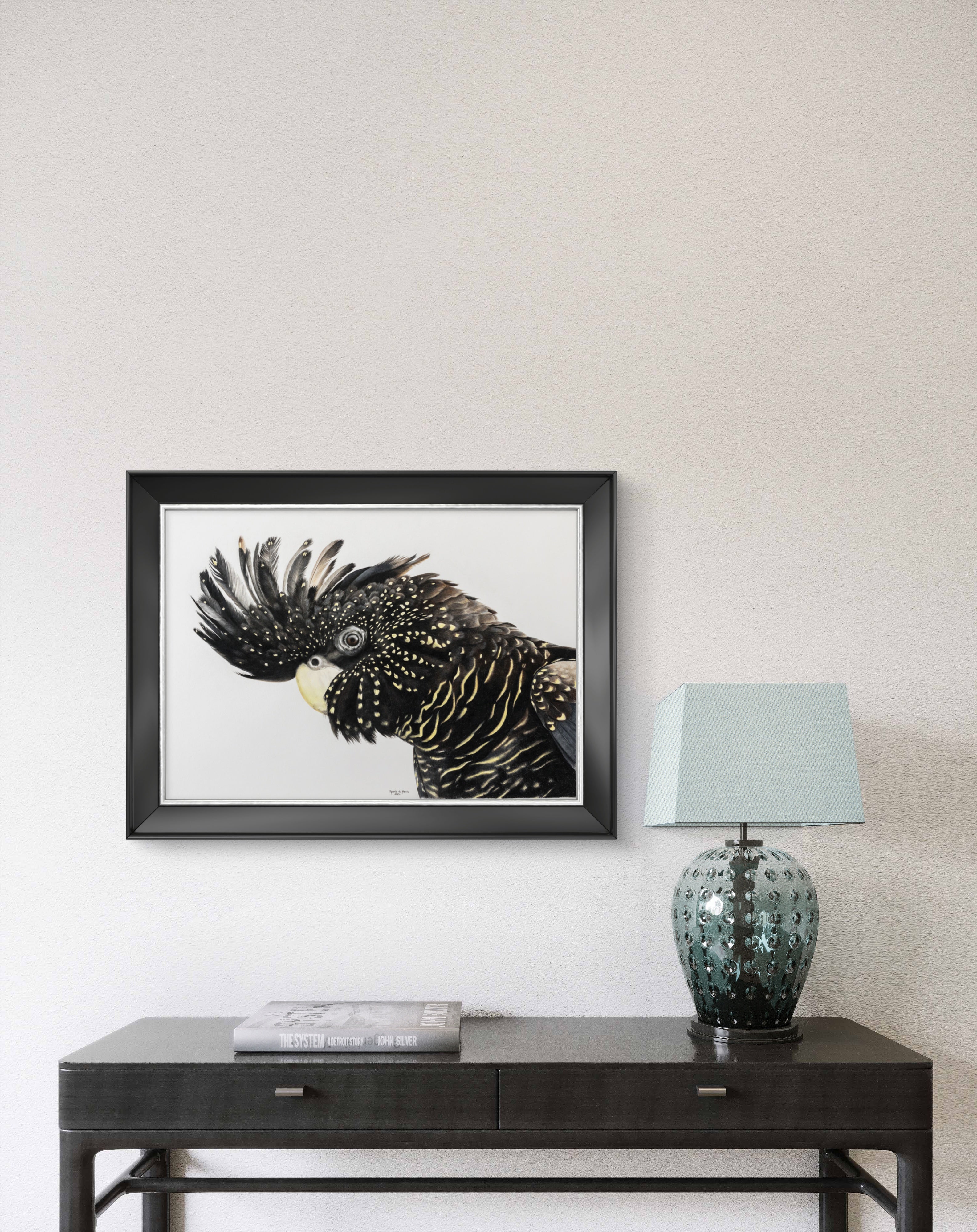 Framed artwork of a bird on a wall above a dark wooden console table with a lamp.