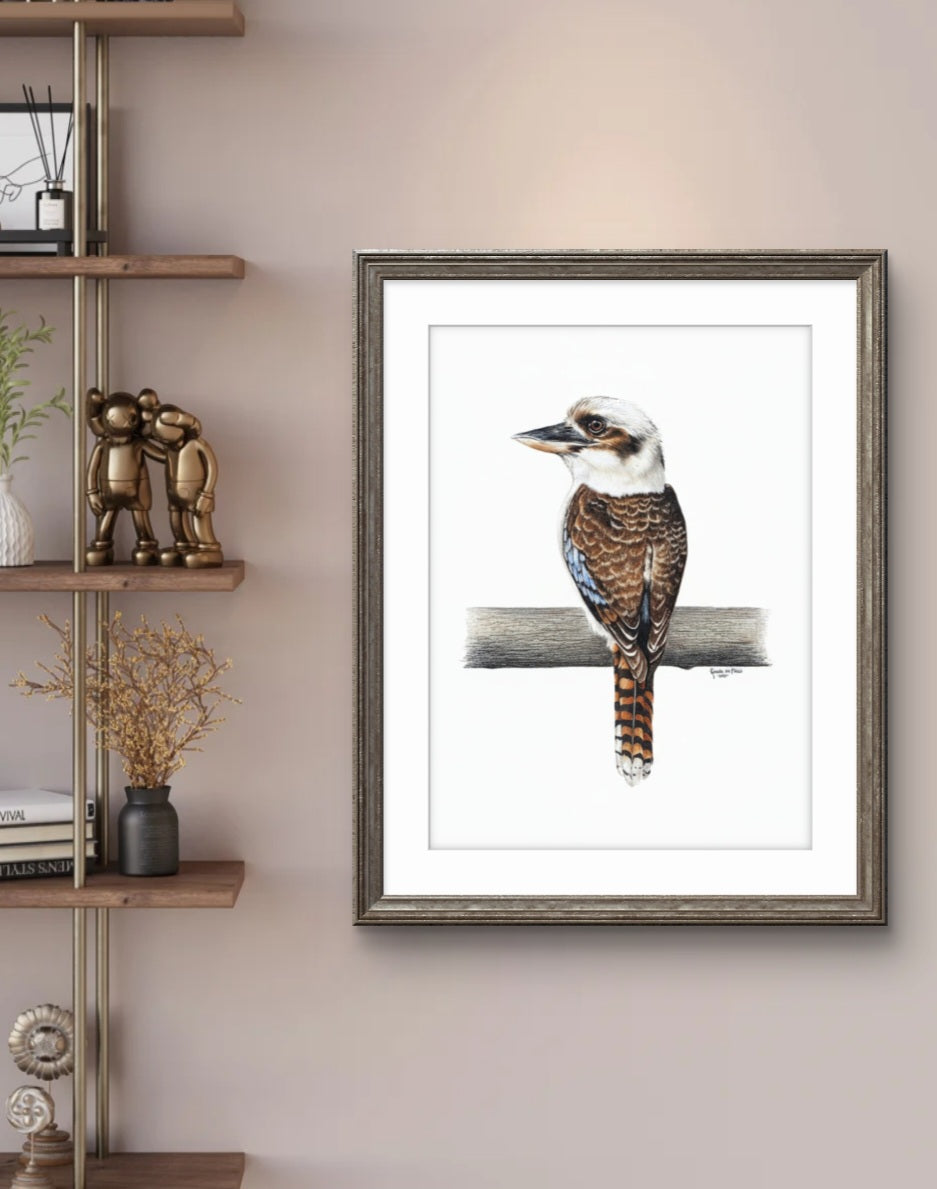 Framed artwork of a bird on a branch in a room with a shelf and decor.