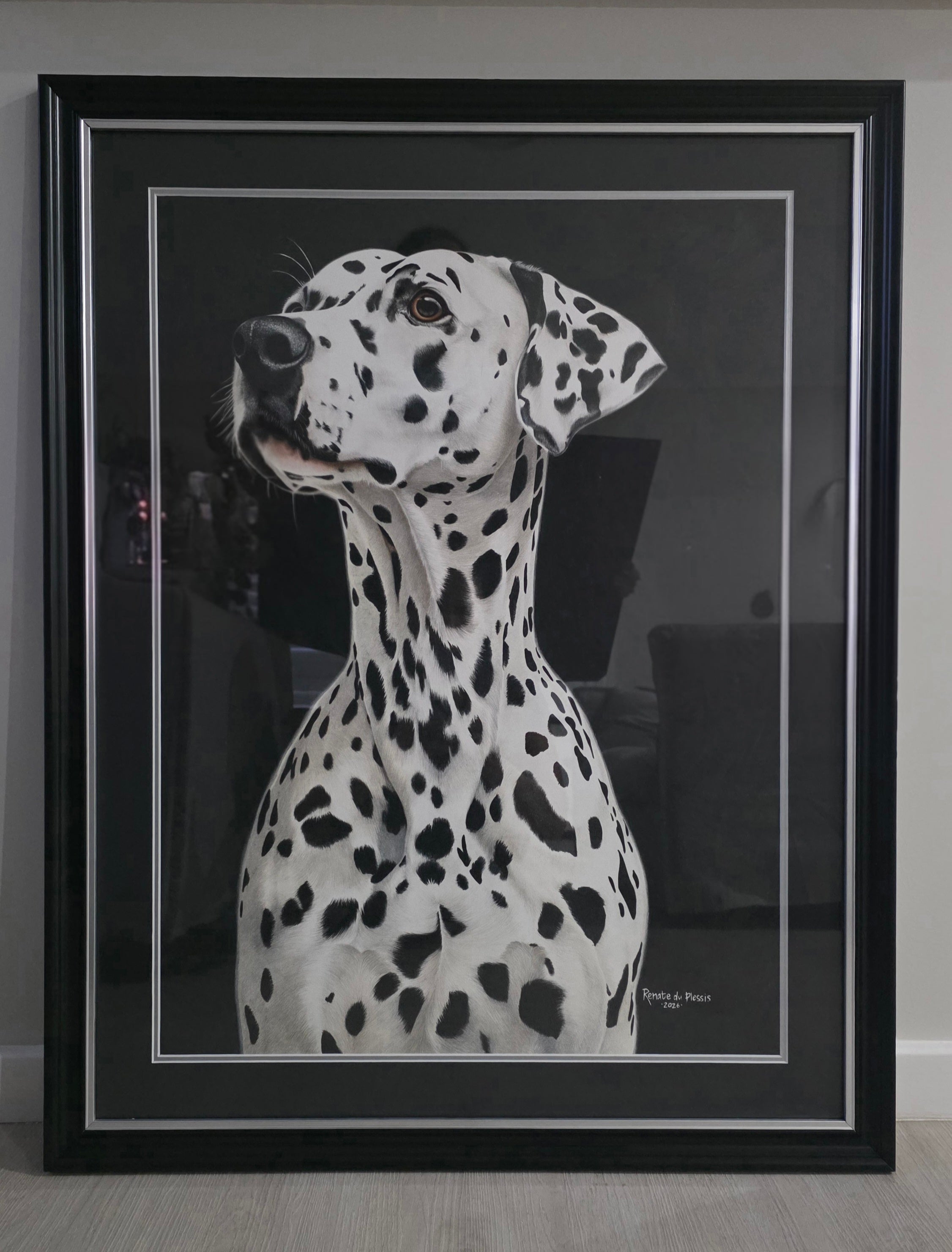 Framed black and white portrait of a Dalmatian dog on a neutral background