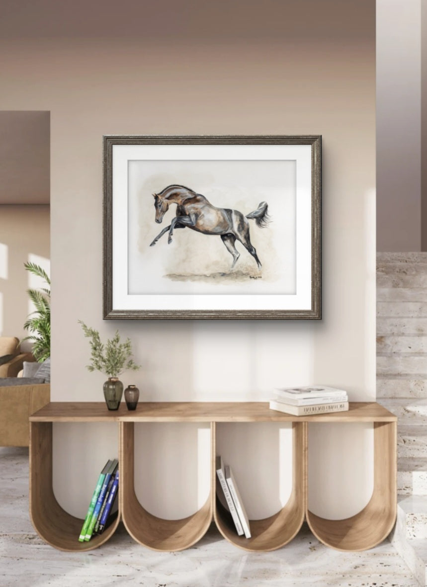 Framed artwork of a horse on a wall above a wooden console table.