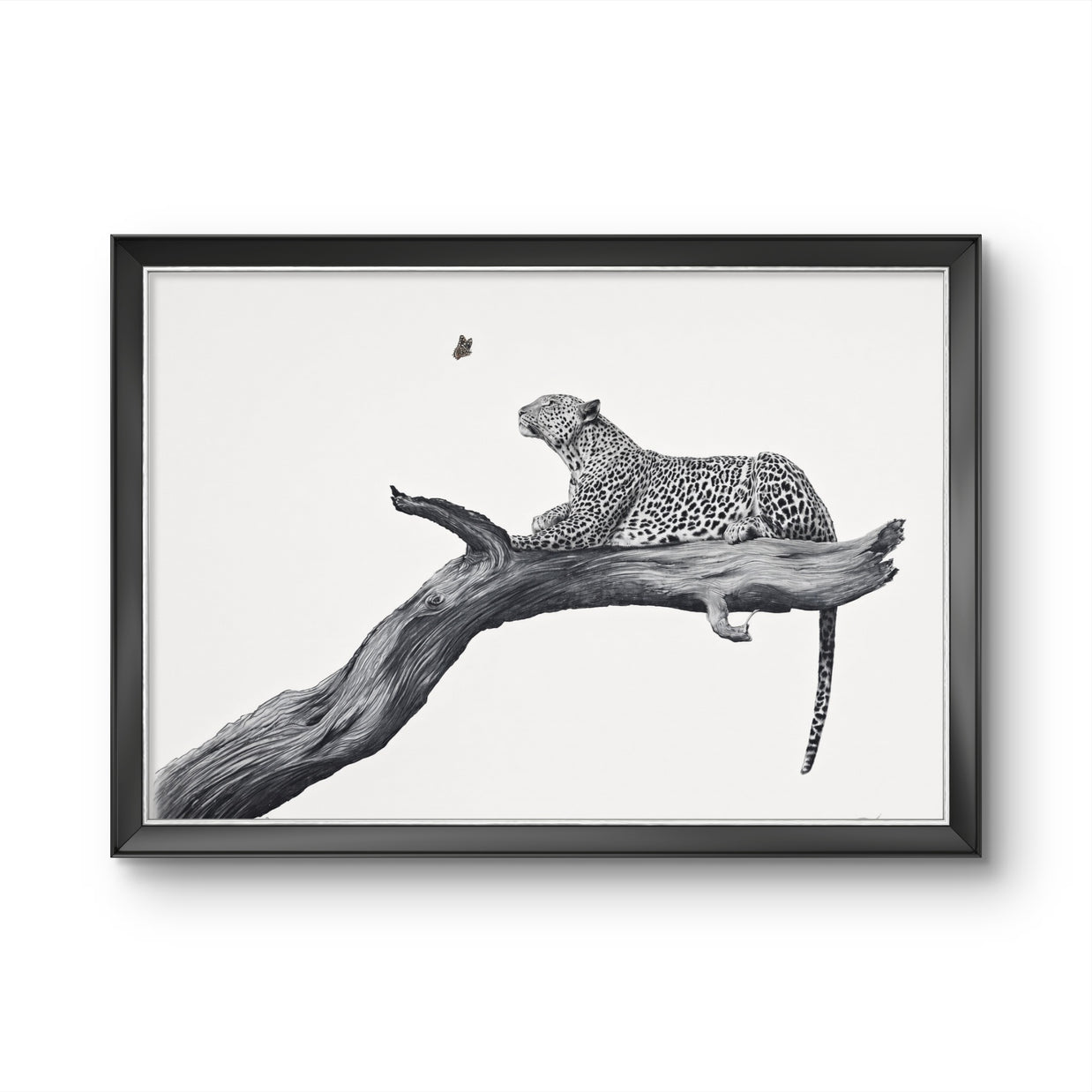 Framed black and white art print featuring a leopard resting on a tree branch, shown against a clean white background.