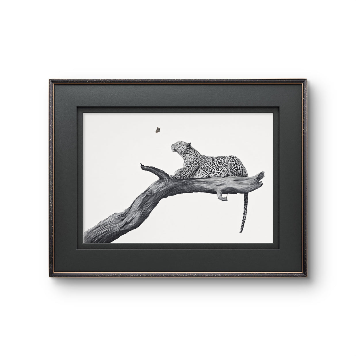 Framed black and white art print of a leopard resting on a tree branch, presented in a dark wood frame against a white background.