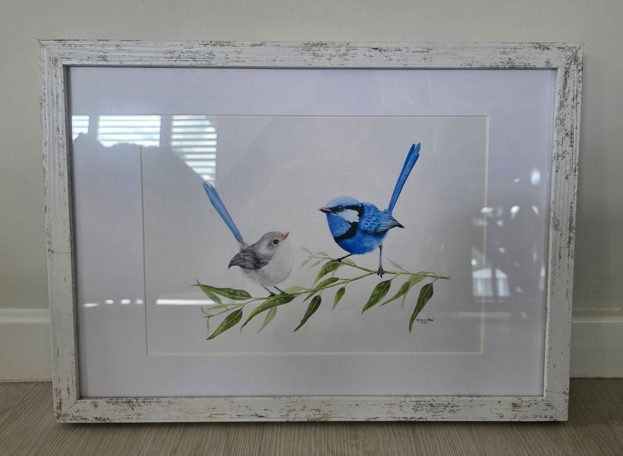 Framed artwork of two birds on a branch with leaves