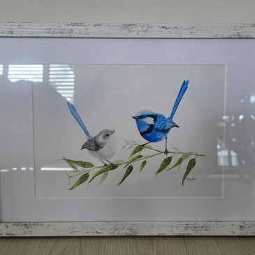 Framed artwork of two birds on a branch with leaves