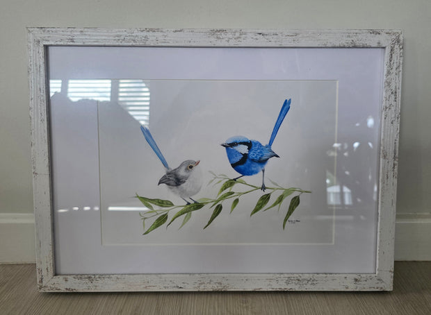 Framed artwork of two birds on a branch with leaves